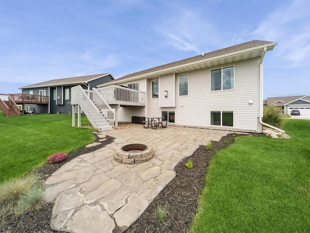 712 Mallard Pointe Dr NW, Bondurant, IA 50035 - back of property with stairway, an outdoor fire pit, a patio area, a deck, and a lawn