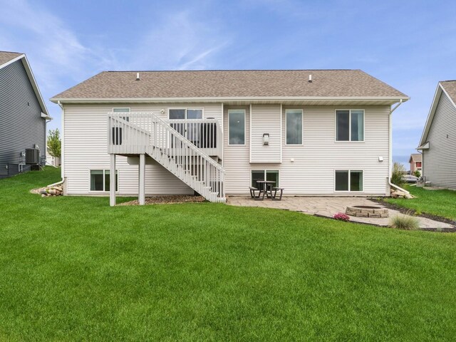 712 Mallard Pointe Dr NW, Bondurant, IA 50035 - rear view of house featuring a patio area, a wooden deck, stairway, and a yard