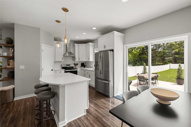 9622 NW 70th Ave, Johnston, IA 50131 - kitchen featuring stainless steel appliances, wall chimney range hood, a center island, light countertops, and backsplash