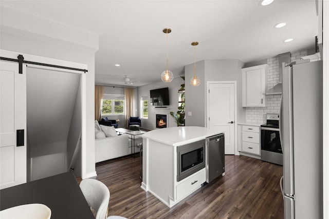 9622 NW 70th Ave, Johnston, IA 50131 - kitchen with stainless steel appliances, a barn door, recessed lighting, white cabinets, and light countertops