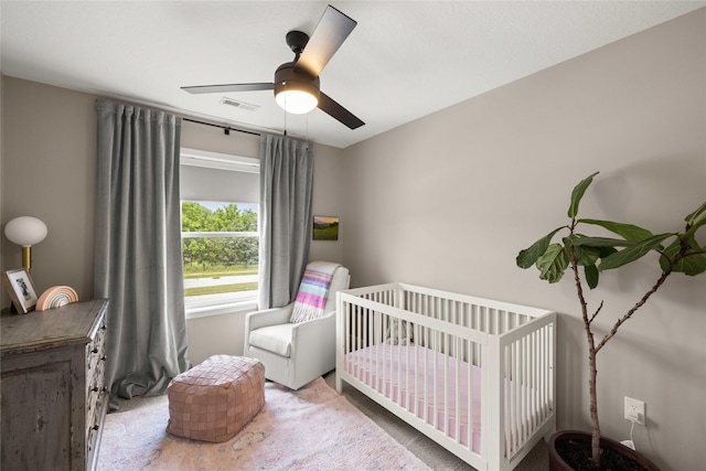 9622 NW 70th Ave, Johnston, IA 50131 - carpeted bedroom with a crib and a ceiling fan