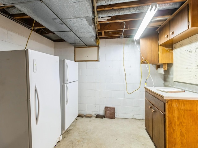 2100 Meadow Brook Dr, West Des Moines, IA 50265 - unfinished basement with freestanding refrigerator and concrete block wall