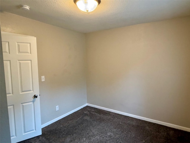 1431 E 19th St, Des Moines, IA 50316 - spare room with dark carpet and a textured ceiling