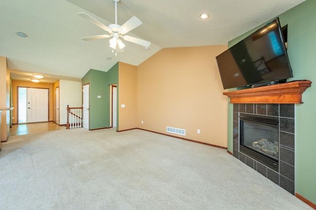 5514 SE 24th St, Des Moines, IA 50320 - unfurnished living room with lofted ceiling, ceiling fan, carpet floors, a tile fireplace, and recessed lighting
