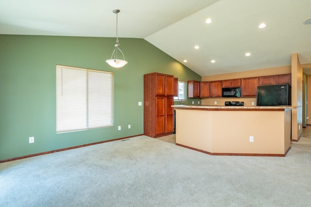 5514 SE 24th St, Des Moines, IA 50320 - kitchen with black microwave, refrigerator, lofted ceiling, brown cabinetry, and light colored carpet