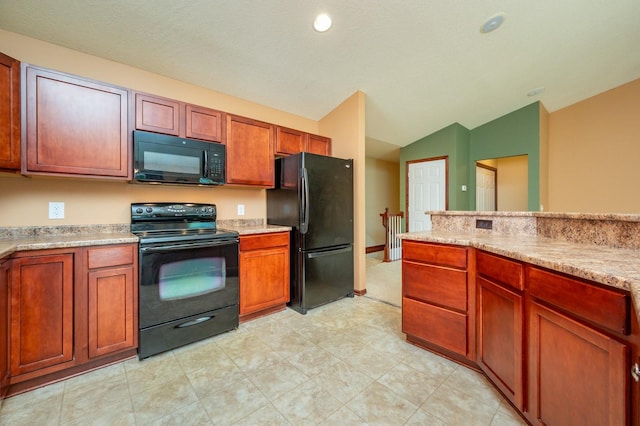 5514 SE 24th St, Des Moines, IA 50320 - kitchen with black appliances, vaulted ceiling, light countertops, and brown cabinetry