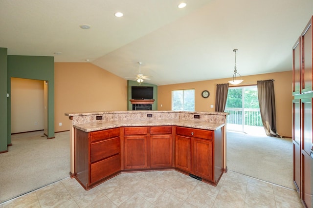 5514 SE 24th St, Des Moines, IA 50320 - kitchen with light carpet, vaulted ceiling, ceiling fan, a center island, and light stone countertops