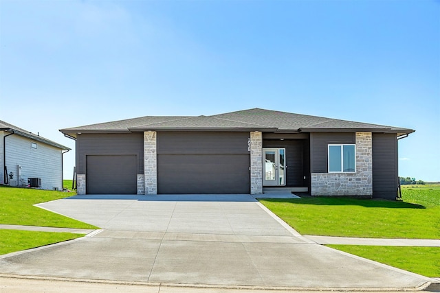 2938 NW Beechwood Dr, Grimes, IA 50111 - prairie-style house with stone siding, a garage, a front yard, and driveway