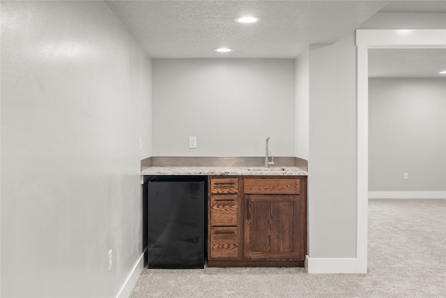 1217 NW Morningside Ct, Grimes, IA 50111 - indoor wet bar with refrigerator, light carpet, a textured ceiling, and recessed lighting