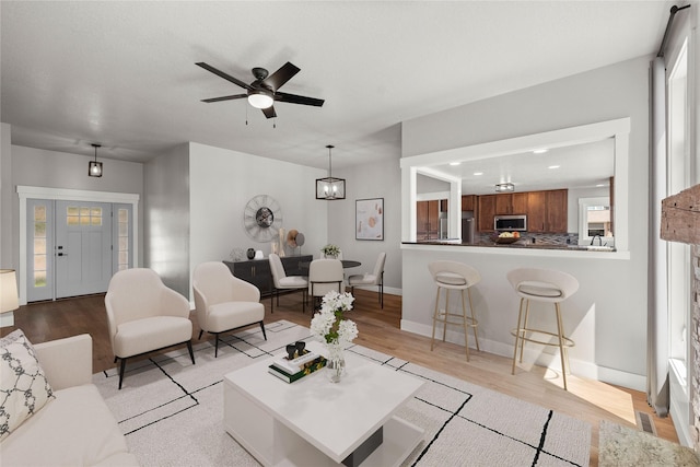 1217 NW Morningside Ct, Grimes, IA 50111 - living area with light wood-style floors, a ceiling fan, plenty of natural light, and recessed lighting