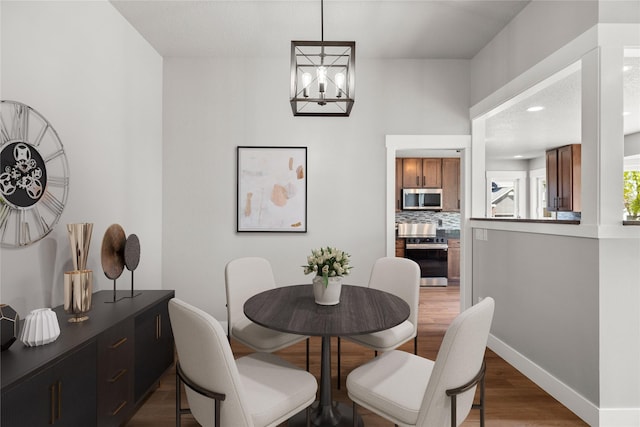 1217 NW Morningside Ct, Grimes, IA 50111 - dining room featuring wood finished floors and a chandelier