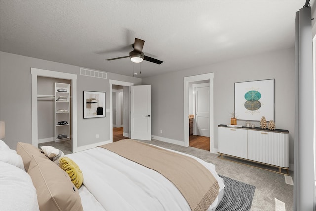 1217 NW Morningside Ct, Grimes, IA 50111 - bedroom featuring light colored carpet, a spacious closet, ensuite bathroom, ceiling fan, and radiator
