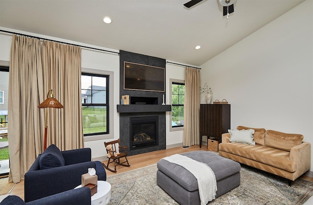 1405 NE Main St, Grimes, IA 50111 - living area featuring wood finished floors, lofted ceiling, recessed lighting, a ceiling fan, and a fireplace