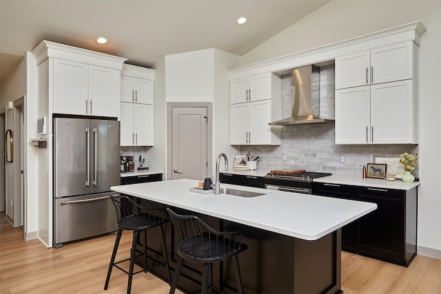 1405 NE Main St, Grimes, IA 50111 - kitchen with appliances with stainless steel finishes, wall chimney range hood, light wood-type flooring, a breakfast bar, and backsplash