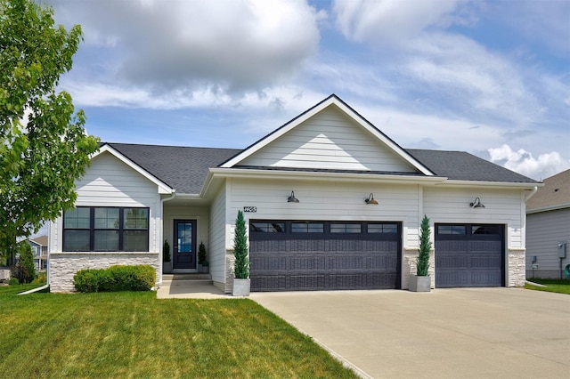 1405 NE Main St, Grimes, IA 50111 - view of front of home with a garage, a front lawn, concrete driveway, and stone siding