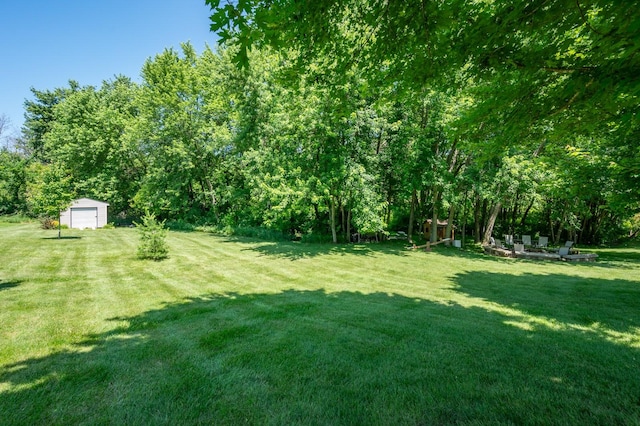105 Everett Cir, Mingo, IA 50168 - view of grassy yard with an outbuilding and a detached garage