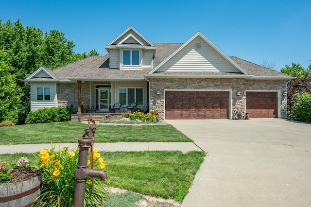 105 Everett Cir, Mingo, IA 50168 - view of front facade featuring a garage, a front lawn, concrete driveway, covered porch, and a shingled roof
