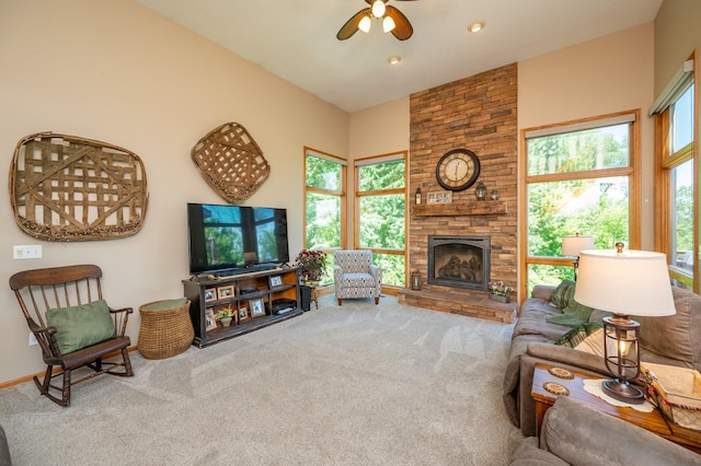 105 Everett Cir, Mingo, IA 50168 - living room featuring ceiling fan, carpet flooring, plenty of natural light, and a stone fireplace
