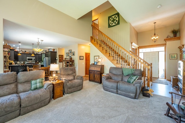 105 Everett Cir, Mingo, IA 50168 - living area featuring stairway, a chandelier, a high ceiling, and light carpet