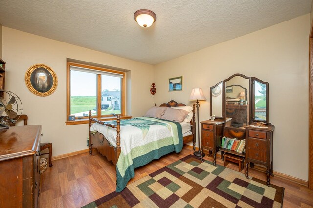 105 Everett Cir, Mingo, IA 50168 - bedroom featuring wood finished floors and a textured ceiling