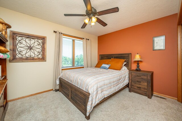 105 Everett Cir, Mingo, IA 50168 - bedroom featuring light carpet, a textured ceiling, and ceiling fan