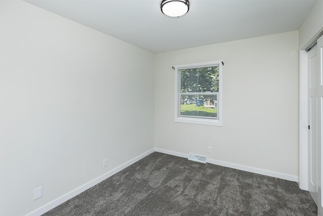 3113 E 36th Ct, Des Moines, IA 50317 - unfurnished bedroom with dark colored carpet and baseboards