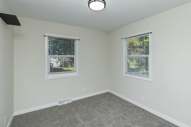 3113 E 36th Ct, Des Moines, IA 50317 - spare room with dark colored carpet and baseboards