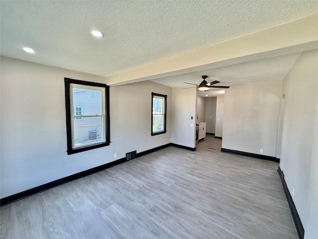 1254 E 16th St, Des Moines, IA 50316 - spare room with light wood-style floors, a textured ceiling, ceiling fan, and recessed lighting