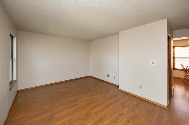 8628 Alpine Dr Unit C, Urbandale, IA 50322 - spare room with wood finished floors and baseboards