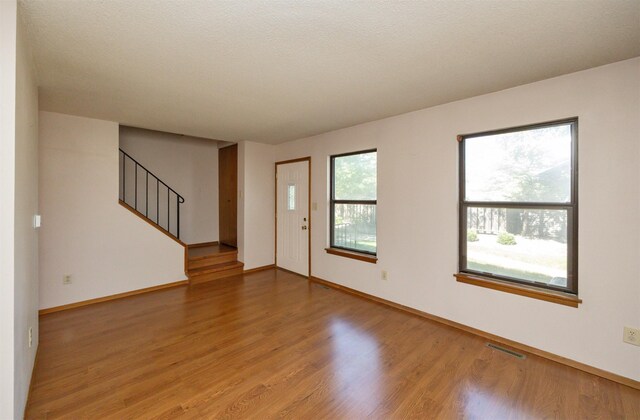 8628 Alpine Dr Unit C, Urbandale, IA 50322 - entrance foyer featuring stairs and wood finished floors