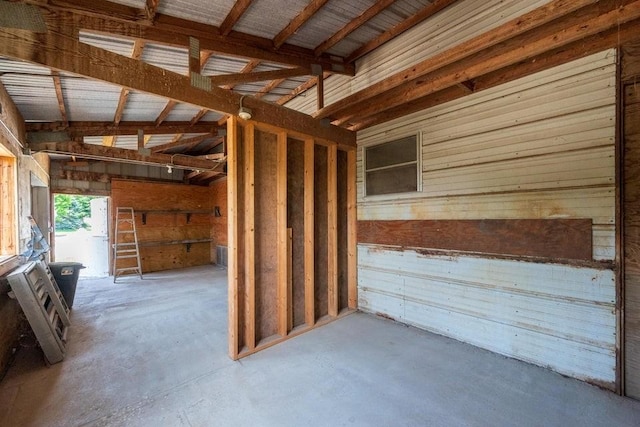 28453 530th Ave, Kelley, IA 50134 - misc room with wooden walls and concrete flooring
