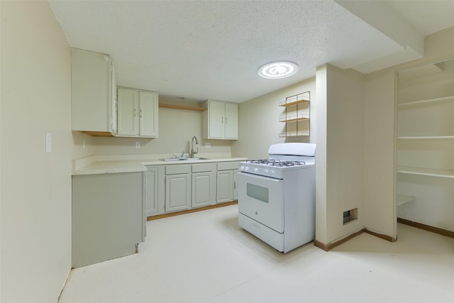 28453 530th Ave, Kelley, IA 50134 - kitchen featuring white gas range, a textured ceiling, and light countertops