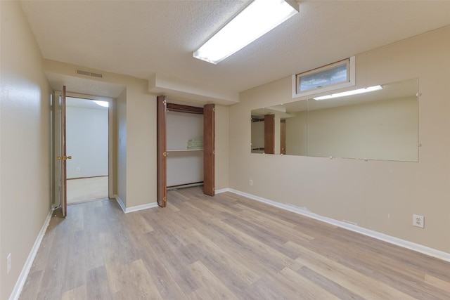 28453 530th Ave, Kelley, IA 50134 - finished basement featuring light wood-style flooring and a textured ceiling