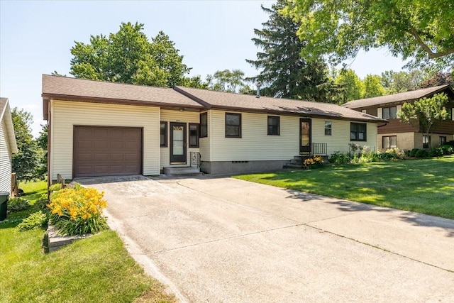 501 N Orchard St N, Brooklyn, IA 52211 - tri-level home featuring a garage, entry steps, concrete driveway, and a front yard