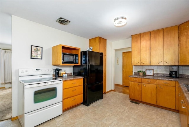 501 N Orchard St N, Brooklyn, IA 52211 - kitchen with black appliances, light floors, brown cabinets, tasteful backsplash, and dark countertops