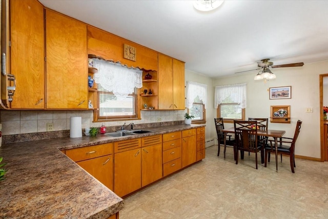 501 N Orchard St N, Brooklyn, IA 52211 - kitchen featuring open shelves, brown cabinetry, backsplash, and light flooring