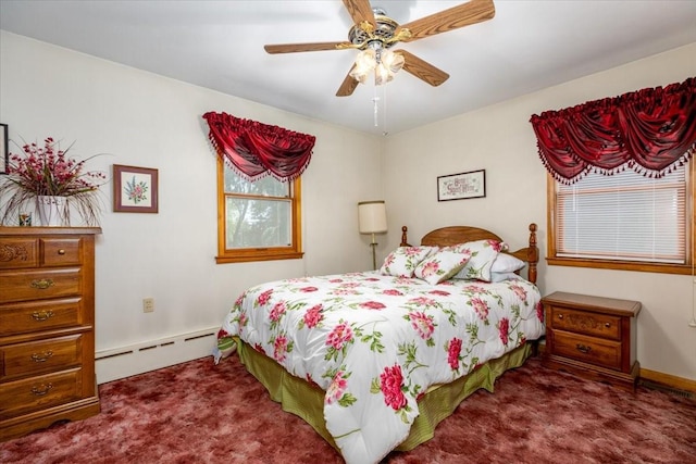 501 N Orchard St N, Brooklyn, IA 52211 - carpeted bedroom featuring a baseboard heating unit and ceiling fan