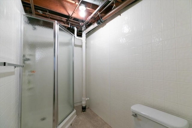 501 N Orchard St N, Brooklyn, IA 52211 - full bath featuring a stall shower, tile patterned flooring, and tile walls