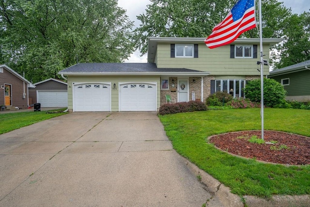 331 E 24th St N, Newton, IA 50208 - view of front of home with a front yard, a garage, driveway, and brick siding