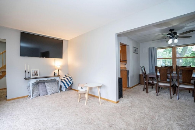 331 E 24th St N, Newton, IA 50208 - carpeted living area with stairs and ceiling fan