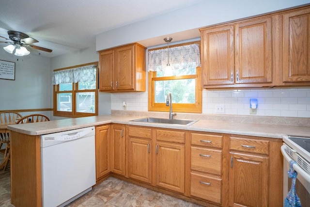 331 E 24th St N, Newton, IA 50208 - kitchen featuring white appliances, ceiling fan, a peninsula, plenty of natural light, and a wainscoted wall