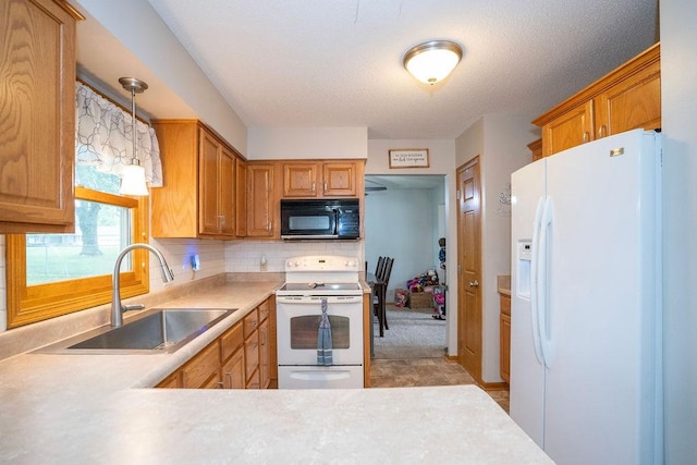331 E 24th St N, Newton, IA 50208 - kitchen with white appliances, light countertops, tasteful backsplash, pendant lighting, and brown cabinets