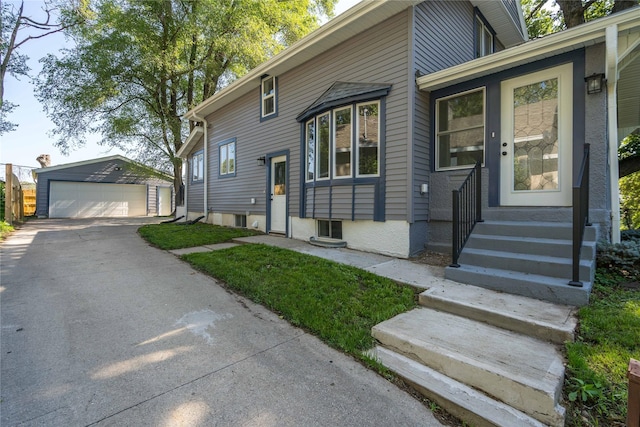 2715 Center St, Des Moines, IA 50312 - view of front of house featuring a garage, an outbuilding, and entry steps