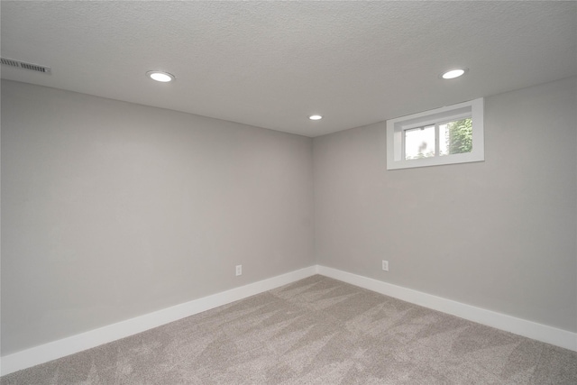 2715 Center St, Des Moines, IA 50312 - below grade area with carpet floors, recessed lighting, and a textured ceiling