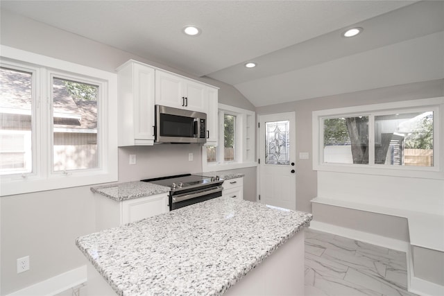 2715 Center St, Des Moines, IA 50312 - kitchen with appliances with stainless steel finishes, recessed lighting, light stone counters, plenty of natural light, and white cabinetry