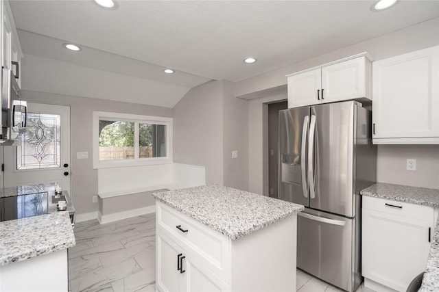 2715 Center St, Des Moines, IA 50312 - kitchen with freestanding refrigerator, recessed lighting, light marble finish flooring, white cabinetry, and light stone counters