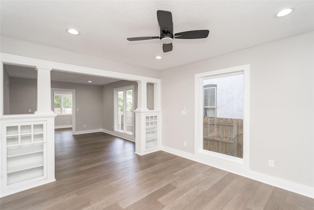 2715 Center St, Des Moines, IA 50312 - unfurnished living room featuring decorative columns, wood finished floors, ceiling fan, and recessed lighting
