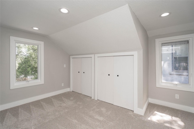 2715 Center St, Des Moines, IA 50312 - additional living space featuring vaulted ceiling, carpet flooring, and recessed lighting