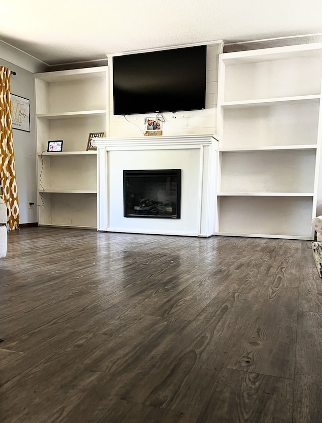 815 Knob Hill Dr, Des Moines, IA 50317 - unfurnished living room featuring wood finished floors and a glass covered fireplace