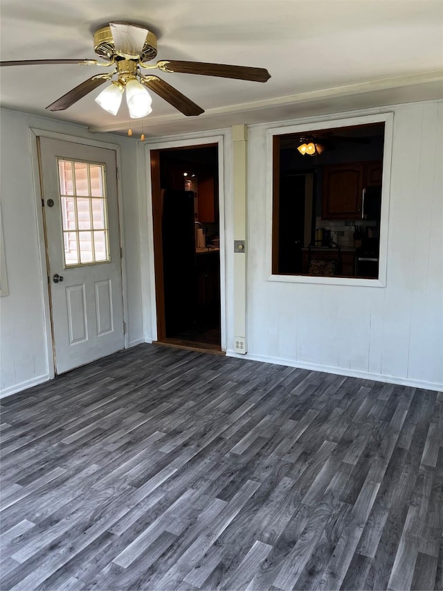 815 Knob Hill Dr, Des Moines, IA 50317 - foyer featuring dark wood-type flooring, a ceiling fan, and a decorative wall